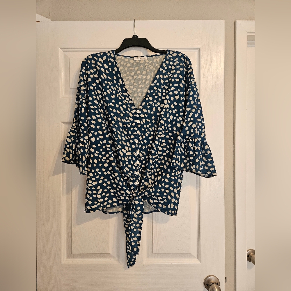 Beautiful dark blue blouse with large white polka dots.